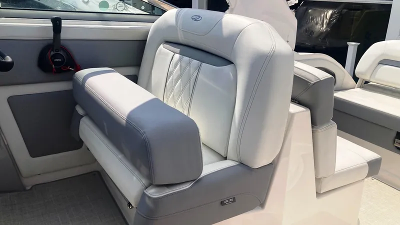 Slide: The Image of 2025 Regal 28 Express boat interior with white seating and control panel. - 6