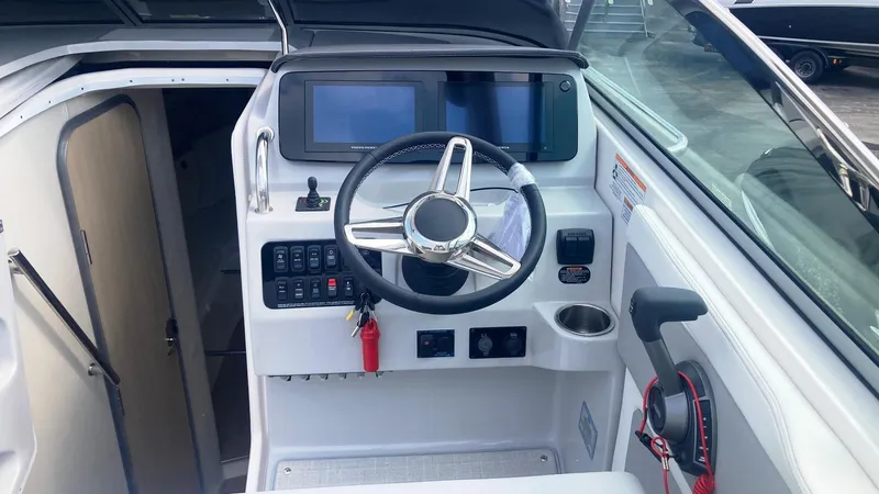 Slide: The Image of 2025 Regal 28 Express boat interior with white cushioned seating and speaker. - 7