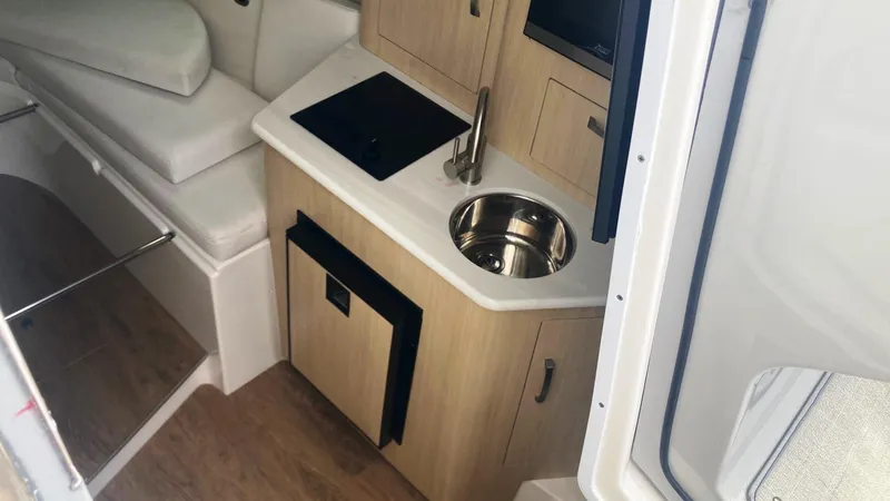 Slide: The Image of 2025 Regal 28 Express boat interior with luxurious gray and white seating. - 8