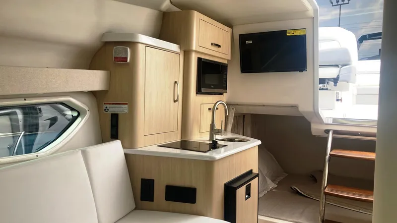 Slide: The Image of 2025 Regal 28 Express boat cockpit with steering wheel and control panel. - 9