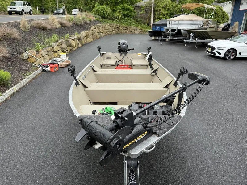 Slide: The Image of 2011 Lowe ANGLER A1667 boat with motor and equipment on a driveway. - 5