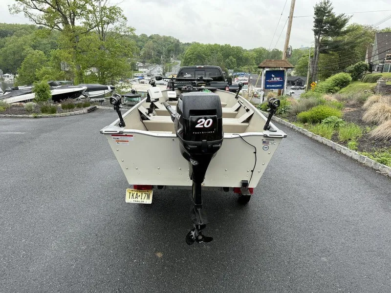 Slide: The Image of 2011 Lowe ANGLER A1667 boat with 20HP motor, parked on a wet driveway. - 8