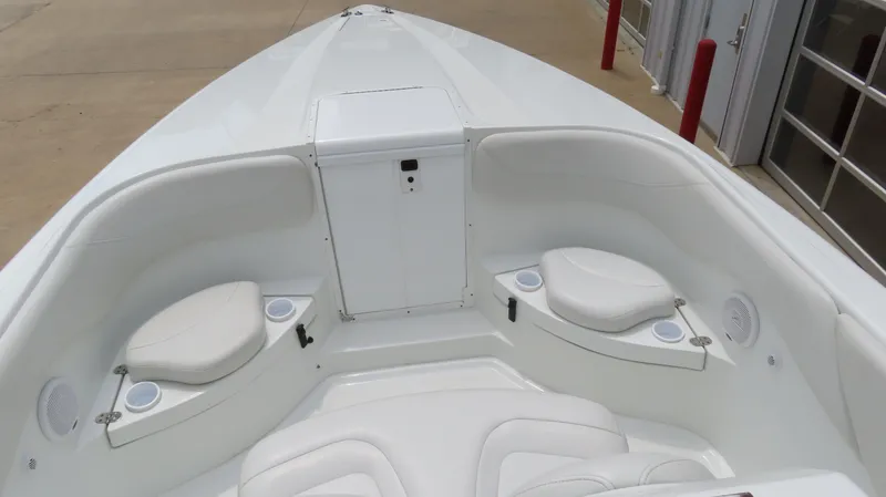 Slide: The Image of 2002 Baja 340 Sportfish boat interior with white seating and storage compartments. - 10