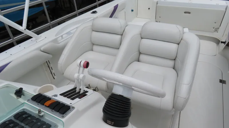Slide: The Image of 2002 Baja 340 Sportfish boat interior with white leather seats and steering wheel. - 12