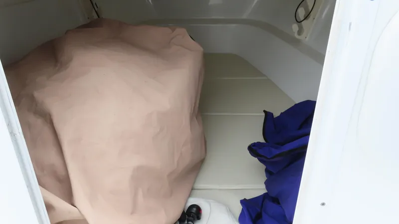 Slide: The Image of 2002 Baja 340 Sportfish interior with covered equipment and storage area. - 16