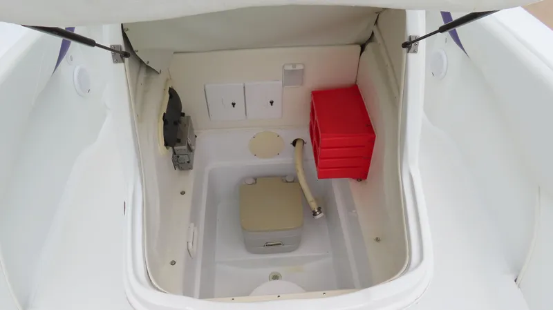 Slide: The Image of 2002 Baja 340 Sportfish storage compartment with red toolbox and equipment. - 18