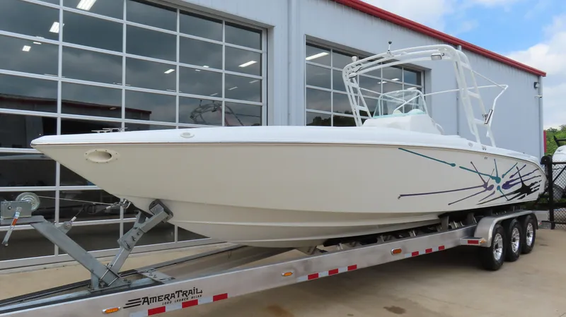 Slide: The Image of 2002 Baja 340 Sportfish boat on trailer outside a garage. - 2