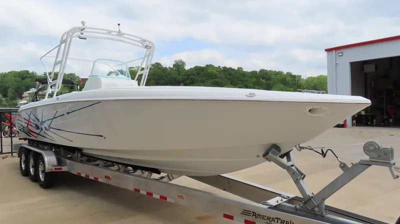 Slide: The Image of 2002 Baja 340 Sportfish boat on trailer, parked outdoors near a building. - 4