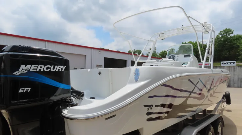 Slide: The Image of 2002 Baja 340 Sportfish boat with Mercury EFI engine, parked outdoors. - 5