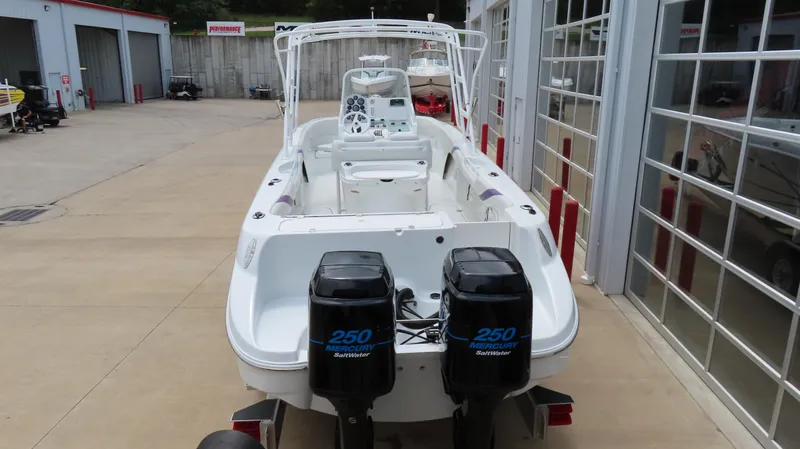 Slide: The Image of 2002 Baja 340 Sportfish boat with twin 250 horsepower engines, parked in a marina. - 6