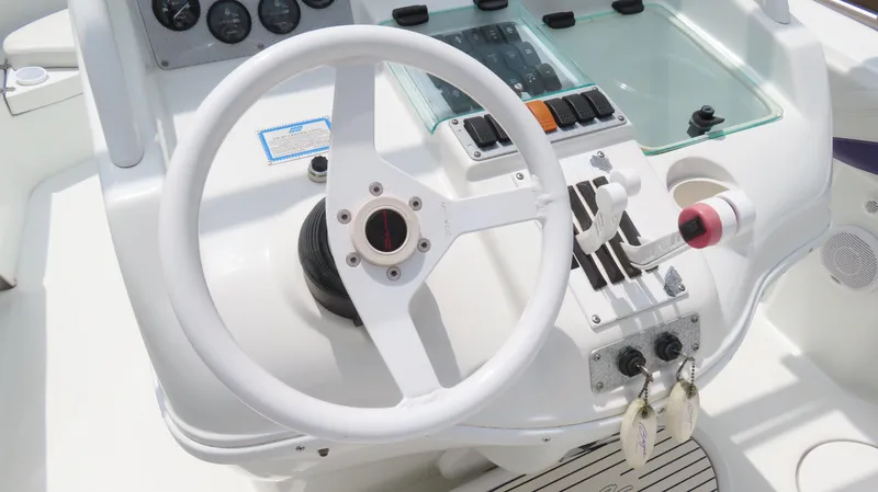 Slide: The Image of Steering console of a 2002 Baja 340 Sportfish boat with controls and gauges. - 7