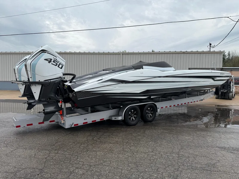 Slide: The Image of 2021 MTI 390X powerboat on trailer with dual 450 engines, parked outdoors. - 4