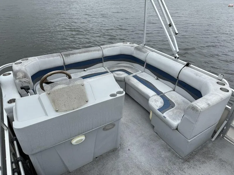Slide: The Image of 2005 Smoker Craft INFINITY pontoon boat interior with seating and steering console on the water. - 11