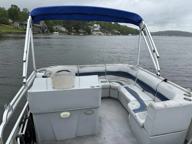 Slide: The Image of 2005 Smoker Craft INFINITY pontoon boat with blue canopy on a calm lake. - 12