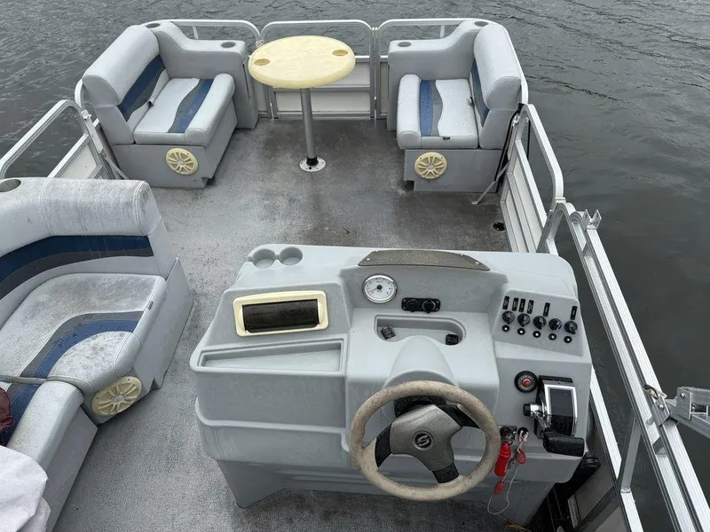 Slide: The Image of 2005 Smoker Craft INFINITY pontoon boat interior with seating and control panel. - 3