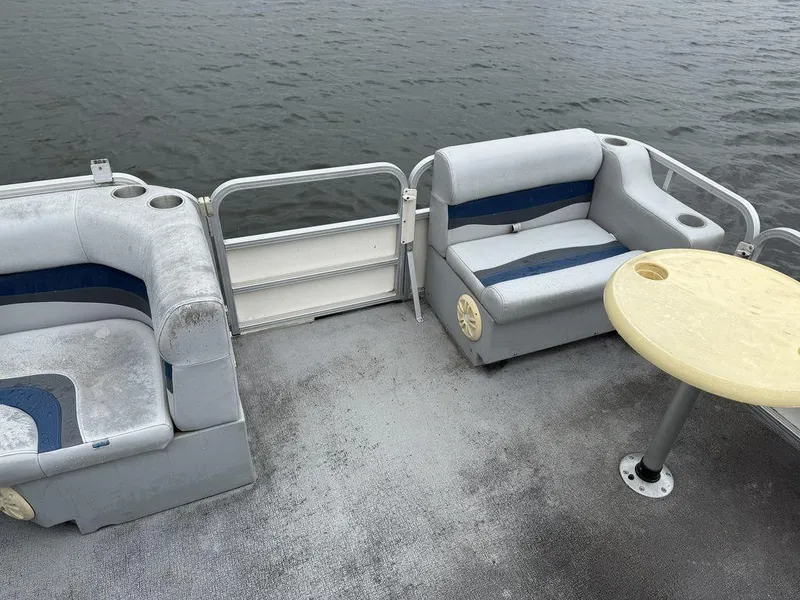 Slide: The Image of 2005 Smoker Craft INFINITY boat interior with seating and table on calm water. - 7