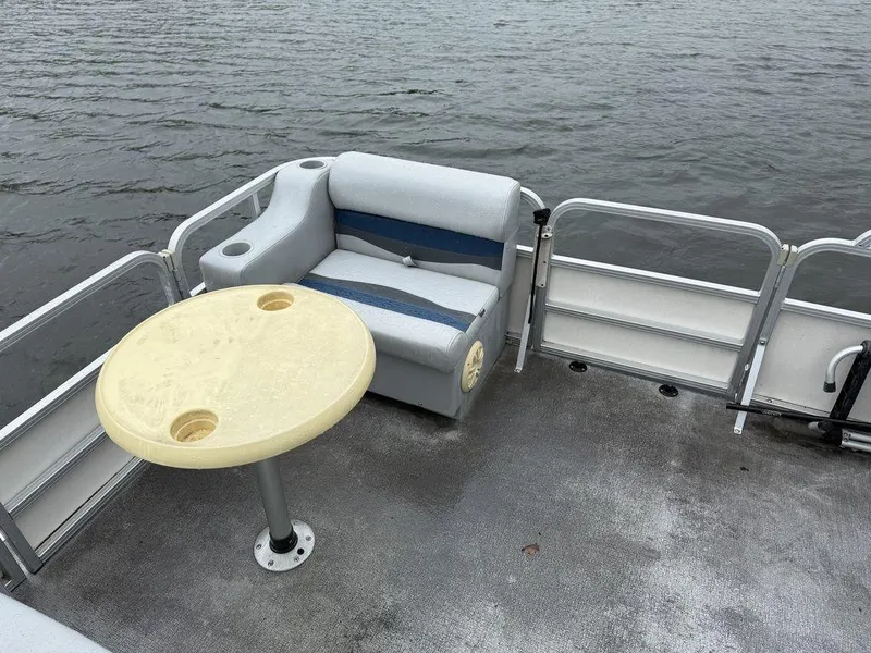Slide: The Image of 2005 Smoker Craft INFINITY boat with seating and table on calm water. - 8