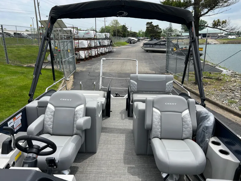 Slide: The Image of 2025 Crest Classic 220 SLRC pontoon boat with luxurious seating and sleek design. - 11