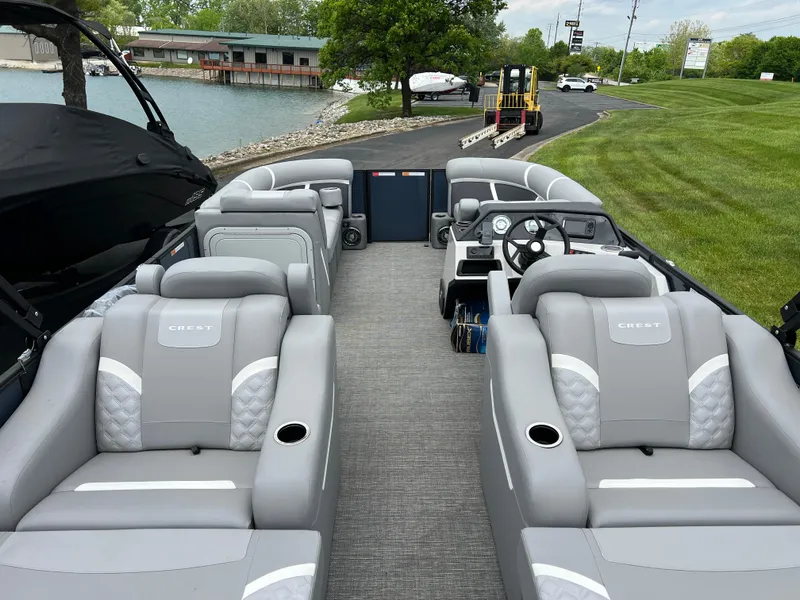 Slide: The Image of 2025 Crest Classic 220 SLRC pontoon boat with luxurious seating and modern design. - 17