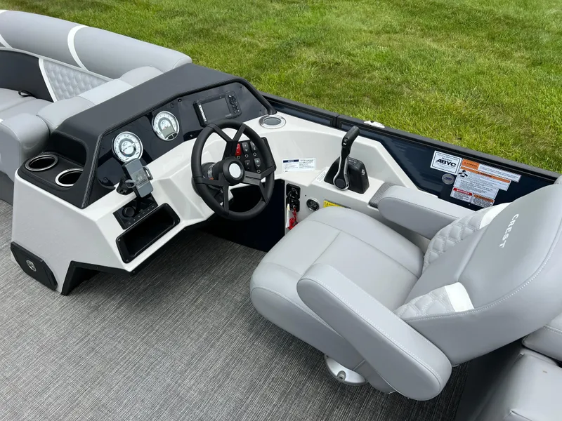 Slide: The Image of 2025 Crest Classic 220 SLRC boat interior with modern dashboard and comfortable seating. - 19