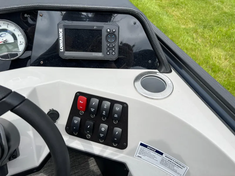 Slide: The Image of Control panel of 2025 Crest Classic 220 SLRC boat with navigation system and switches. - 21