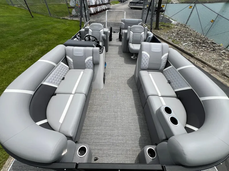 Slide: The Image of 2025 Crest Classic 220 SLRC pontoon boat with spacious gray seating and modern design. - 8