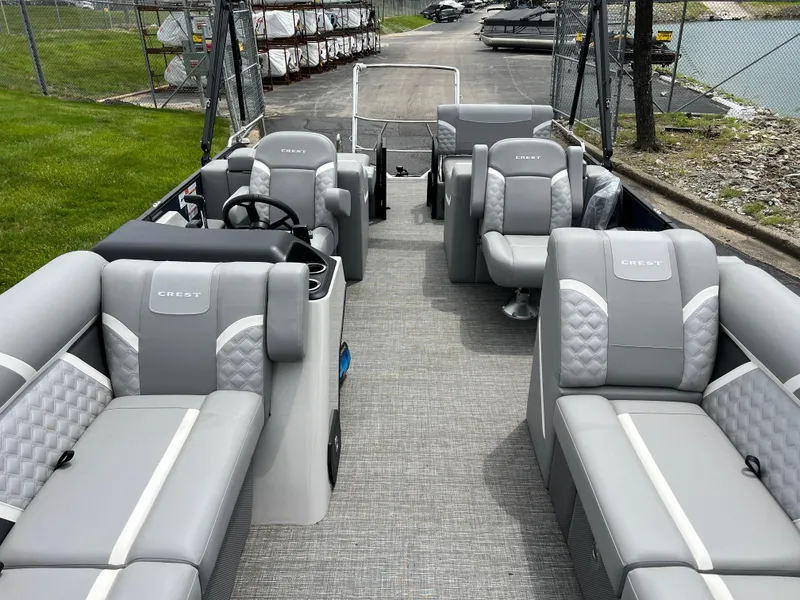 Slide: The Image of 2025 Crest Classic 220 SLRC pontoon boat with luxurious gray seating and spacious layout. - 9