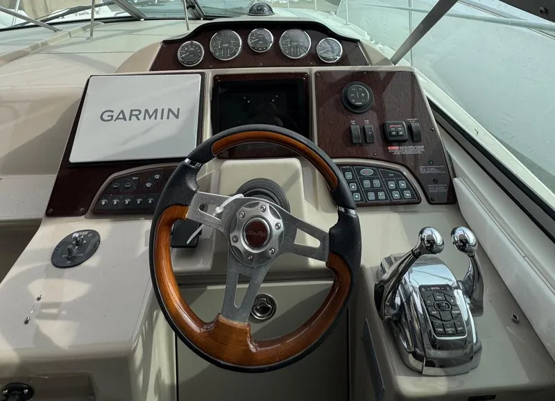 Slide: The Image of Cockpit of 2008 Sea Ray 330 Sundancer with Garmin navigation and wood-accented steering wheel. - 10