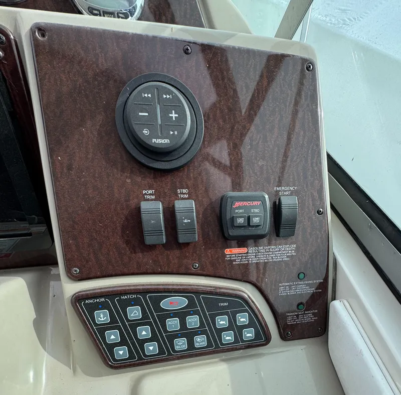Slide: The Image of Control panel of a 2008 Sea Ray 330 Sundancer boat with various switches and buttons. - 13