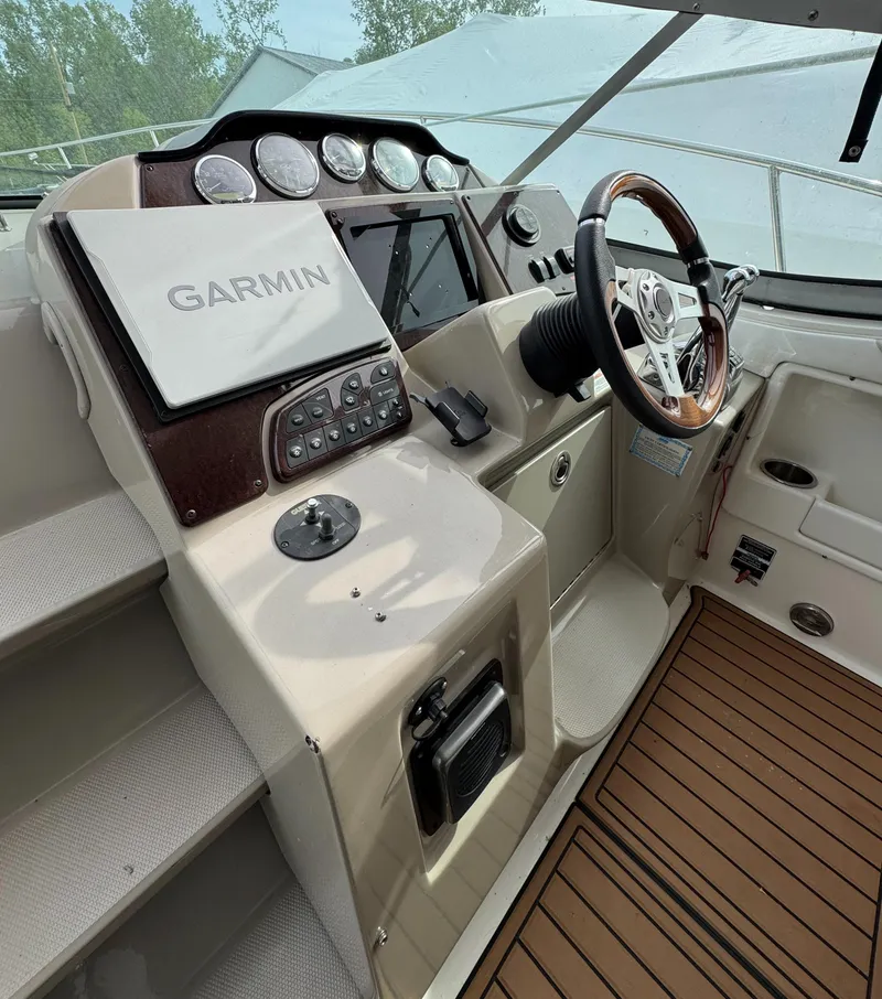Slide: The Image of 2008 Sea Ray 330 Sundancer helm with Garmin navigation and wood-accented steering wheel. - 15