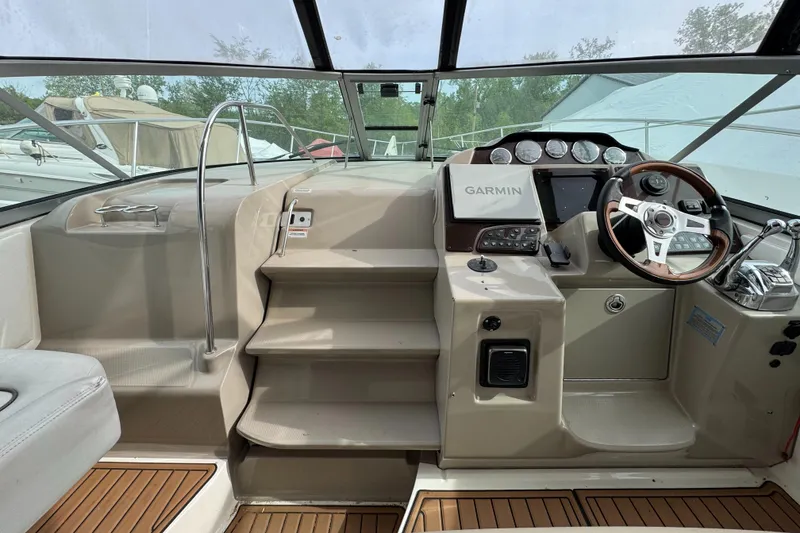 Slide: The Image of 2008 Sea Ray 330 Sundancer helm with Garmin navigation and wood accents. - 18