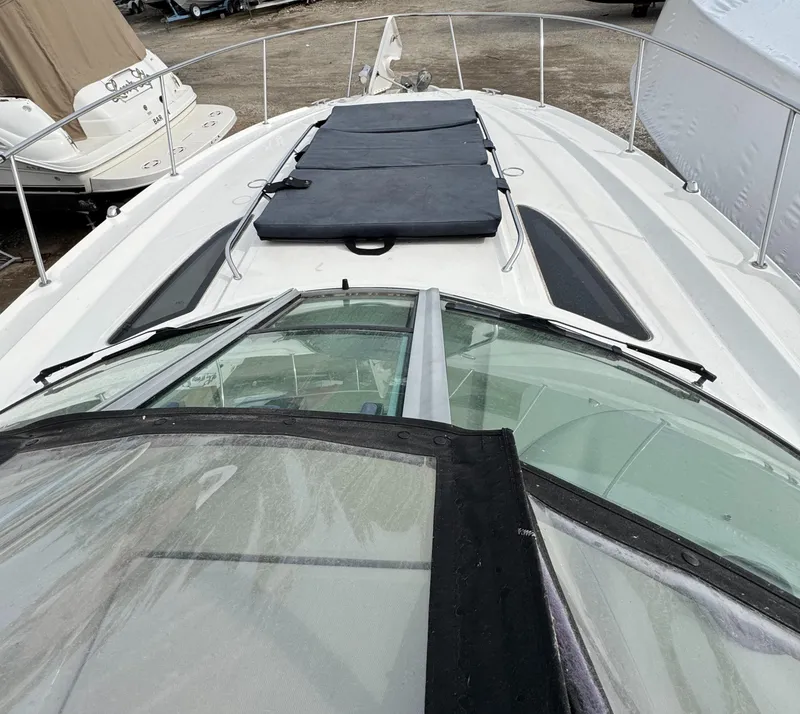 Slide: The Image of 2008 Sea Ray 330 Sundancer boat deck with sun pads and railing. - 2