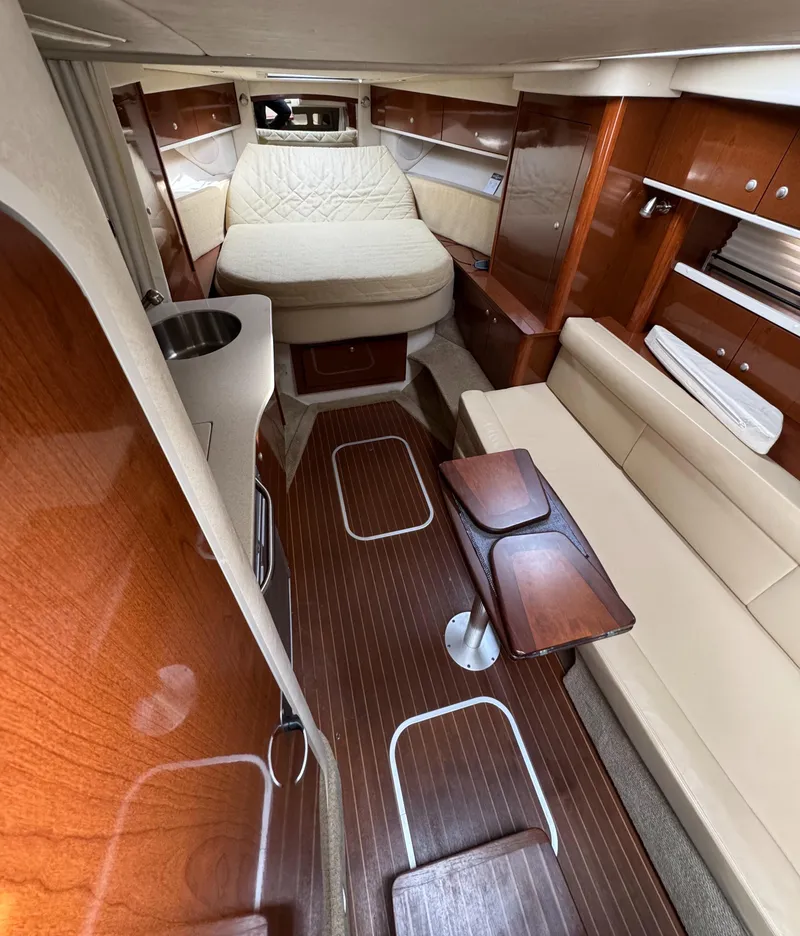 Slide: The Image of Interior of 2008 Sea Ray 330 Sundancer with wood finishes and cozy seating area. - 5