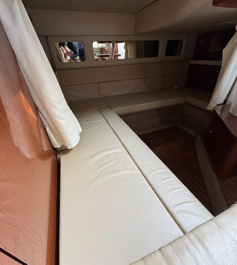 Slide: The Image of 2008 Sea Ray 330 Sundancer cabin interior with beige seating and wood accents. - 8