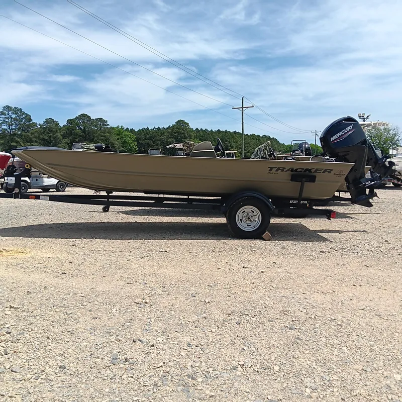 The Image of 2025 Tracker Grizzly 1754 SC boat on trailer, parked outdoors under blue sky. - 0