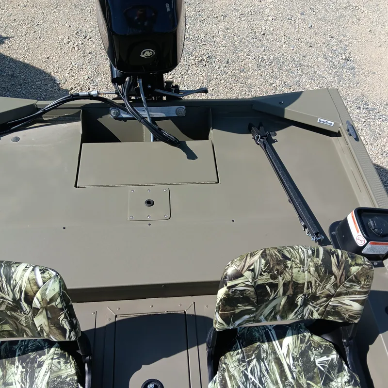 Slide: The Image of 2025 Tracker Grizzly 1754 SC boat interior with camouflage seats and motor. - 11