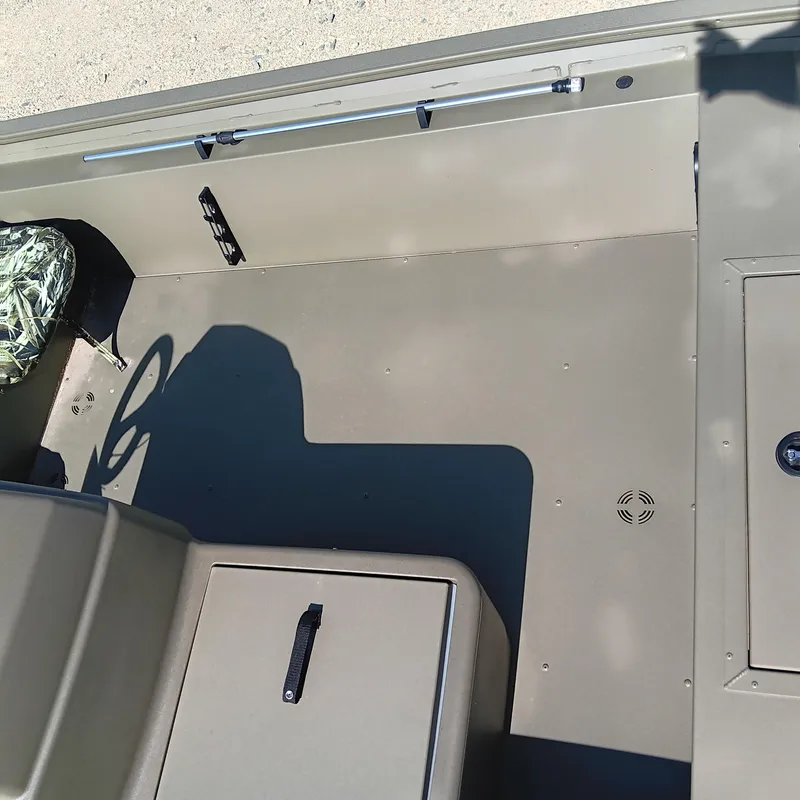 Slide: The Image of 2025 Tracker Grizzly 1754 SC boat interior with steering wheel and storage compartments. - 8