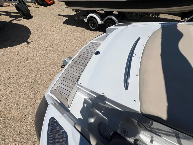 Slide: The Image of 2002 Chris-Craft 22 Launch Bow Rider boat, partial view with trailer in background. - 12