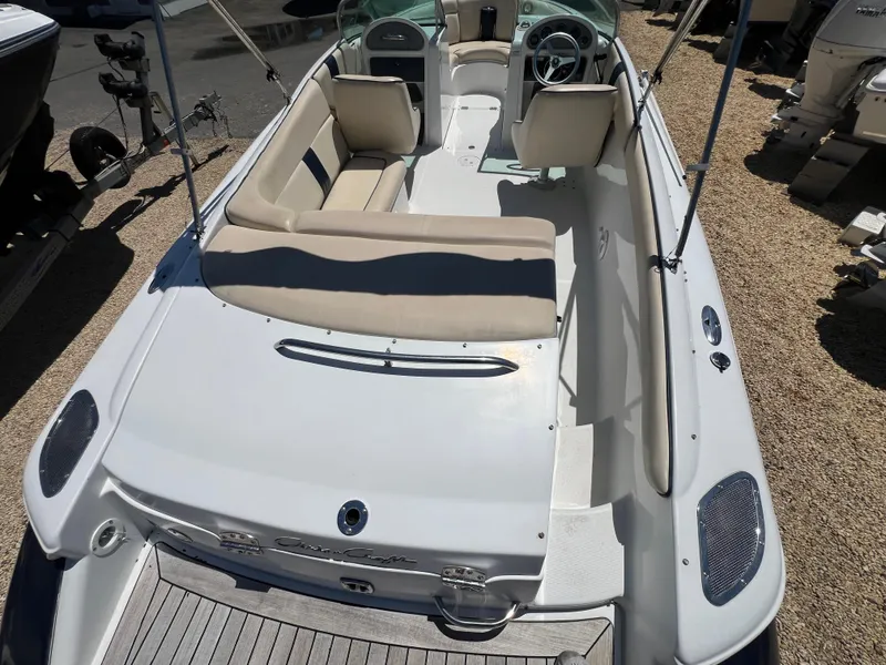 Slide: The Image of 2002 Chris-Craft 22 Launch Bow Rider boat with beige seating and sleek design. - 13