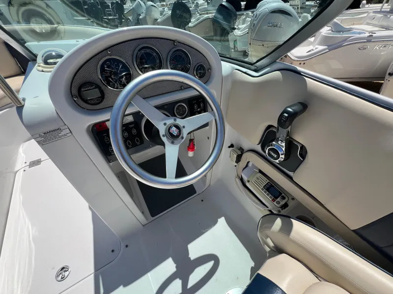 Slide: The Image of 2002 Chris-Craft 22 Launch Bow Rider cockpit with steering wheel and control panel. - 16