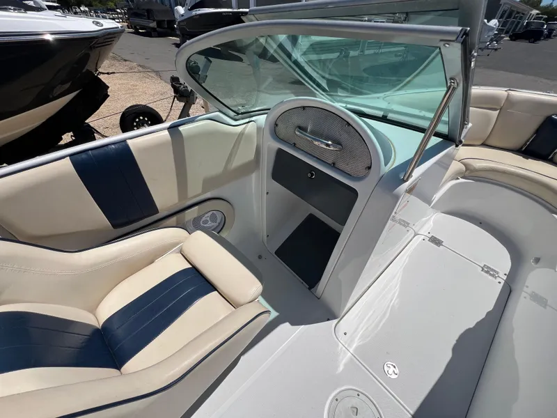 Slide: The Image of 2002 Chris-Craft 22 Launch Bow Rider interior with blue and beige seating. - 17