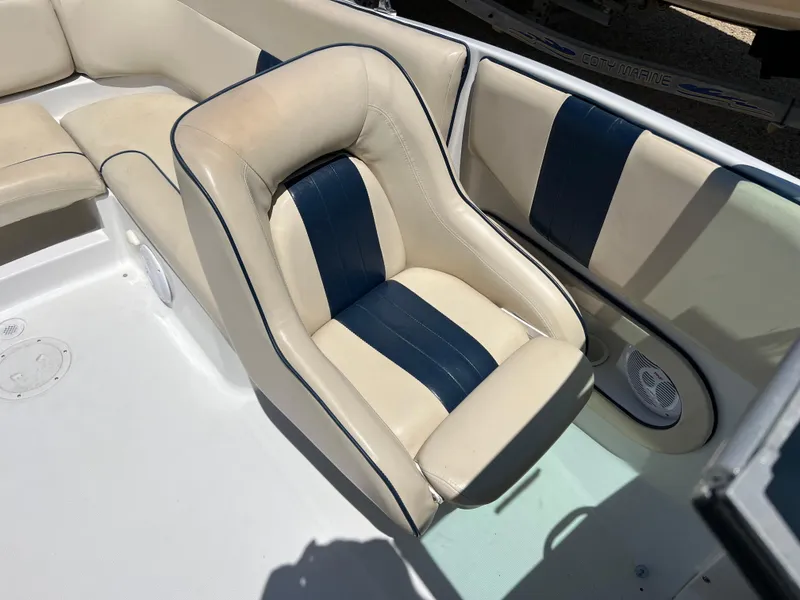 Slide: The Image of 2002 Chris-Craft 22 Launch Bow Rider interior with beige and navy seating. - 18