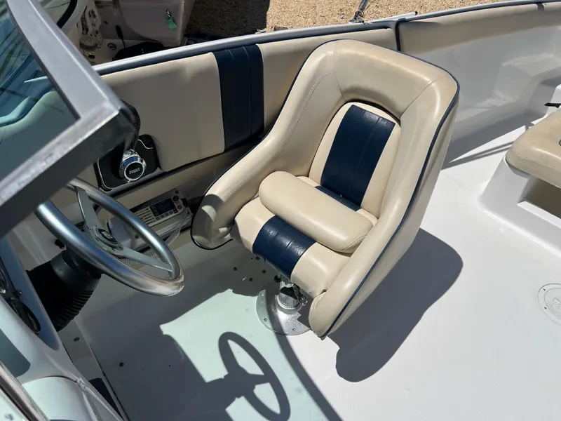 Slide: The Image of 2002 Chris-Craft 22 Launch Bow Rider interior with beige and navy seating. - 19