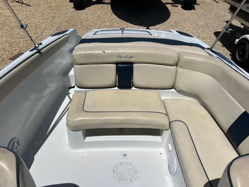 Slide: The Image of 2002 Chris-Craft 22 Launch Bow Rider with beige seating and blue accents. - 21