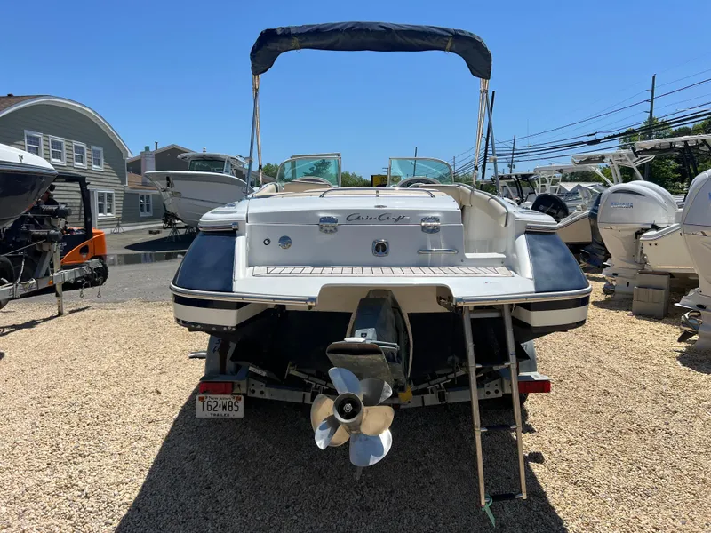 Slide: The Image of 2002 Chris-Craft 22 Launch Bow Rider boat on trailer, rear view, sunny day. - 6