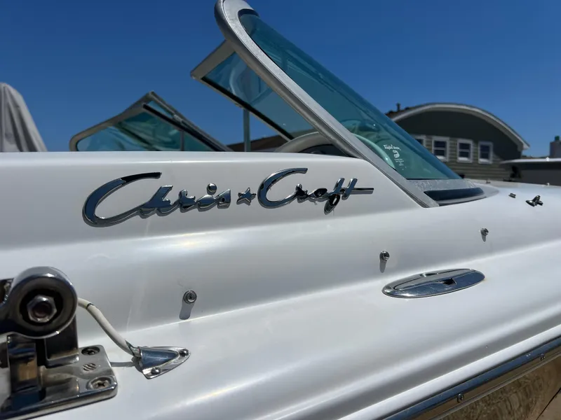 Slide: The Image of 2002 Chris-Craft 22 Launch Bow Rider boat with sleek design and logo detail. - 8