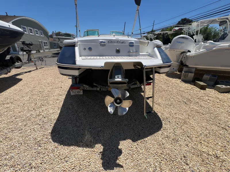 Slide: The Image of 2002 Chris-Craft 22 Launch Bow Rider boat on gravel lot, rear view. - 9