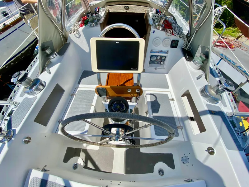 Slide: The Image of Cockpit of a 1979 Valiant 37 sailboat with steering wheel and navigation equipment. - 12