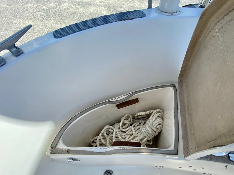 Slide: The Image of Open storage compartment on 1979 Valiant 37 sailboat with coiled rope inside. - 14