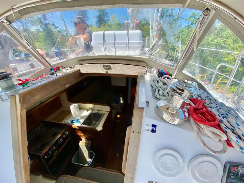 Slide: The Image of 1979 Valiant 37 sailboat cockpit with ropes, winches, and cabin entrance. - 18